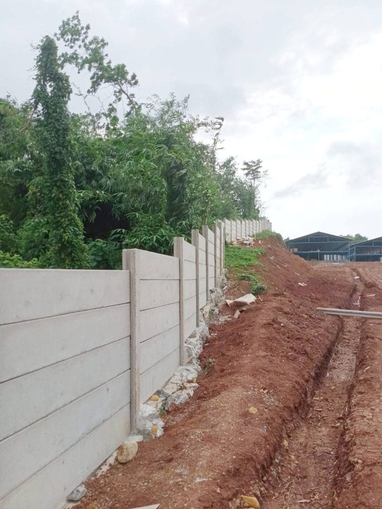 Proses pemasangan pagar panel beton yang rapi dan kokoh oleh tim ahli Artha Konstruksi di area perumahan.